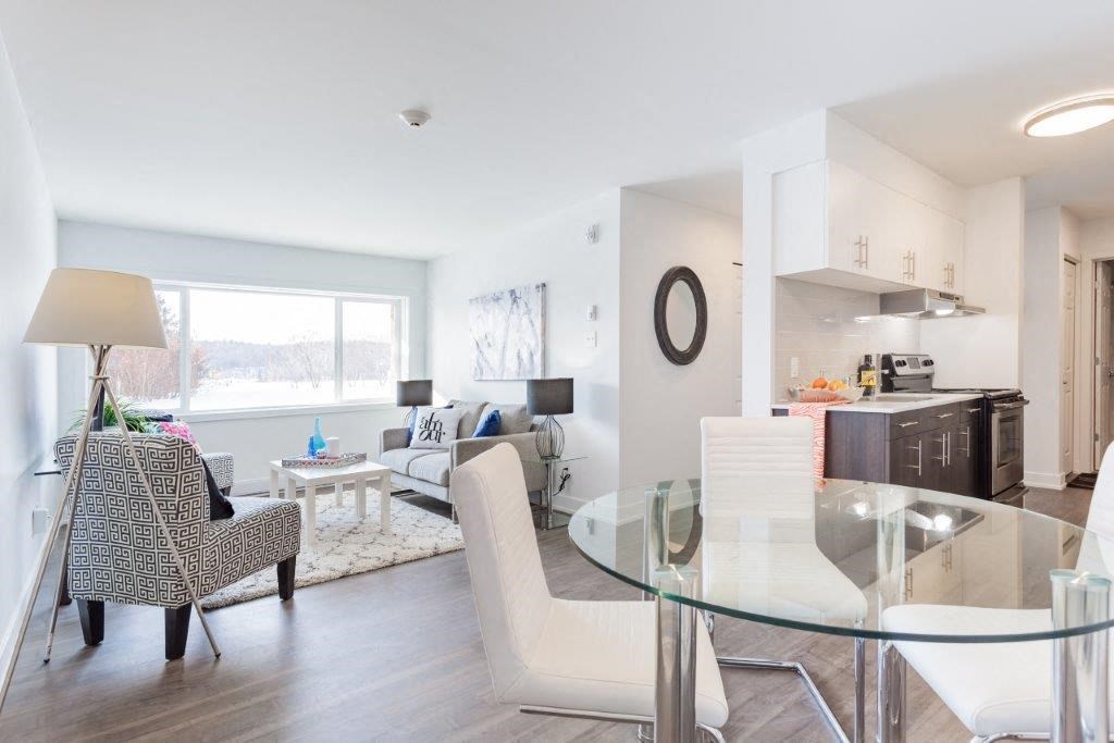 a living room and dining room with a glass table