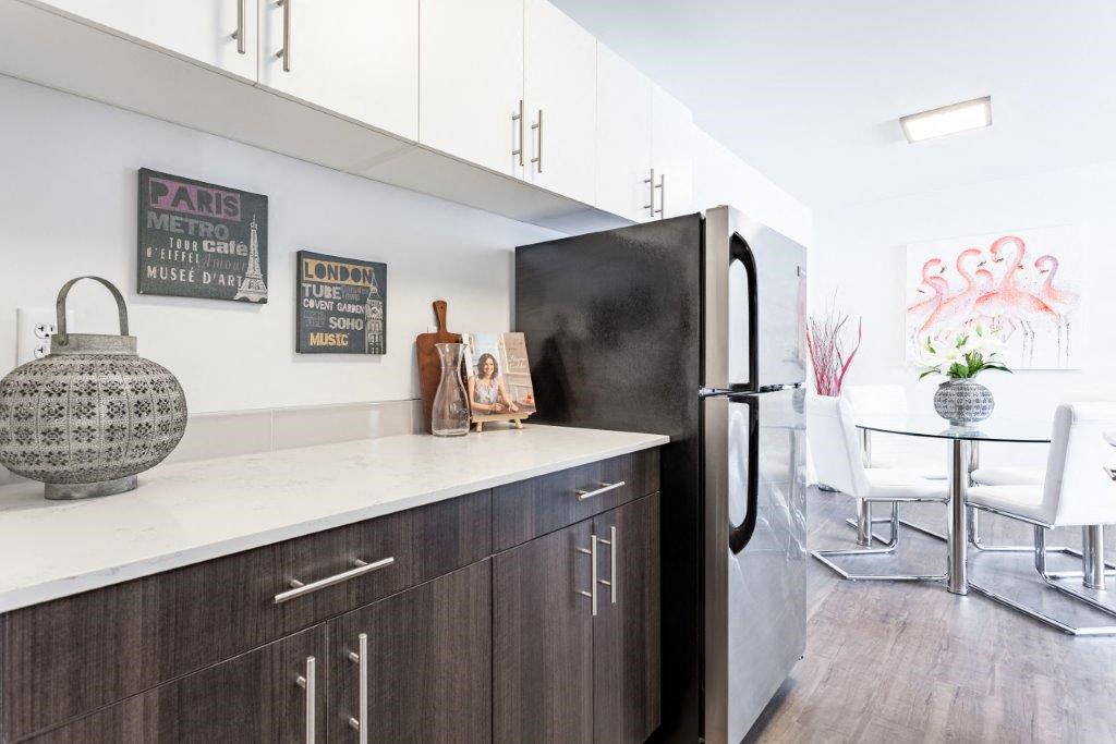 a kitchen with a refrigerator and a table