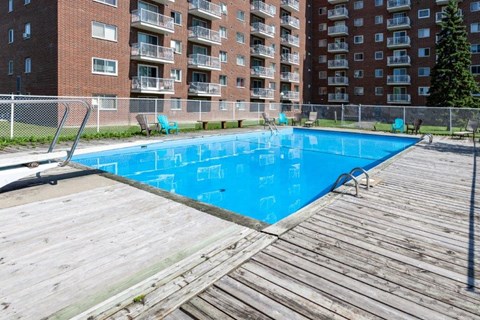 a swimming pool in front of an apartment building