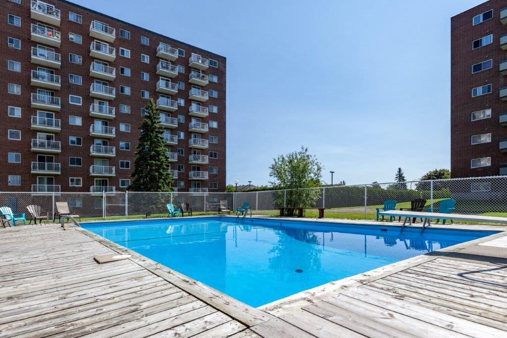 a swimming pool with a building in the background