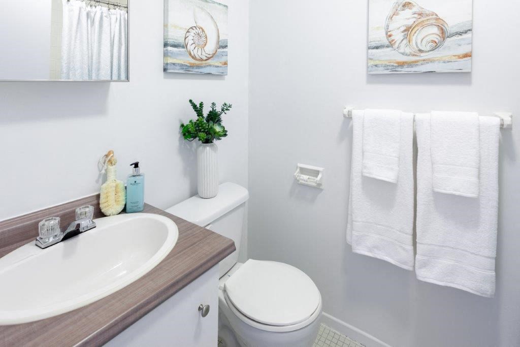 a white bathroom with a sink and a toilet