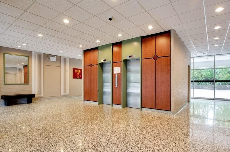 a large lobby with three elevators in a building