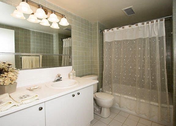 a bathroom with a toilet and a sink and a shower