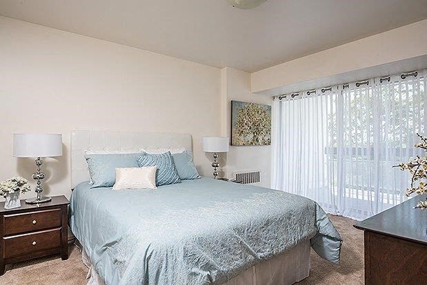 a bedroom with a large bed and a window