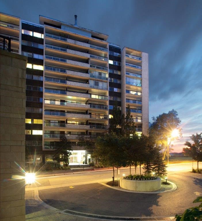 an office building at night with the street in front of it