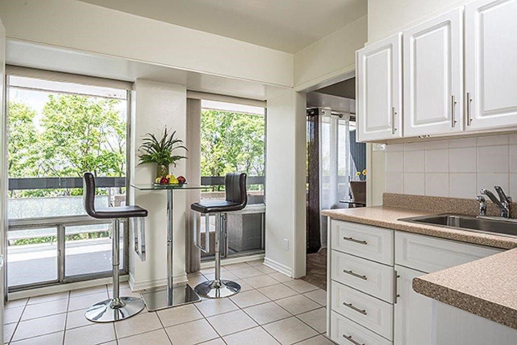 a kitchen with a table and chairs and a sink