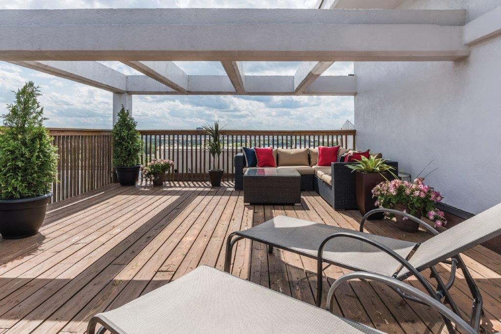 a large deck with a couch and chairs on it