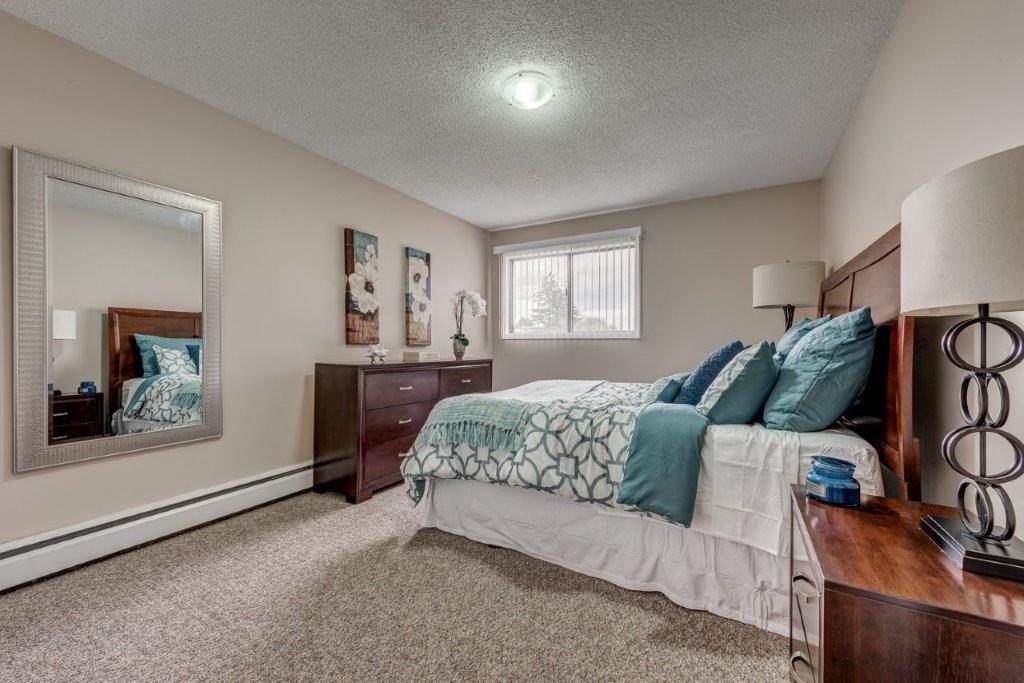 a bedroom with a bed and a mirror