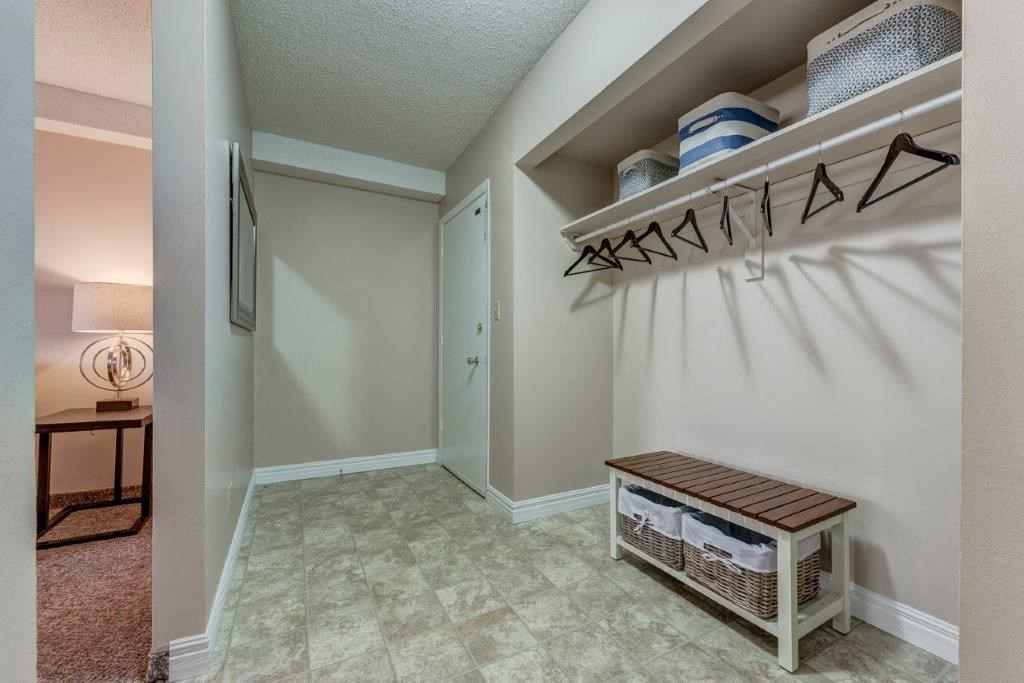 a bedroom with a closet and a hallway with a table