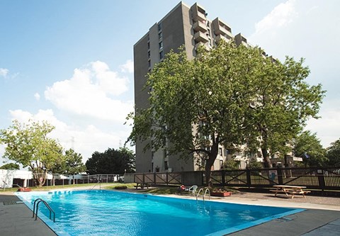 a swimming pool with a building in the background