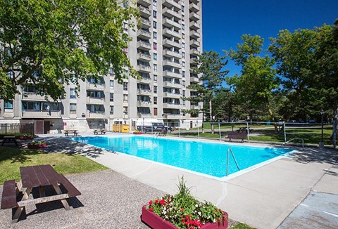 a swimming pool in front of an apartment building