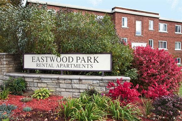 a sign for eastwood park in front of a building