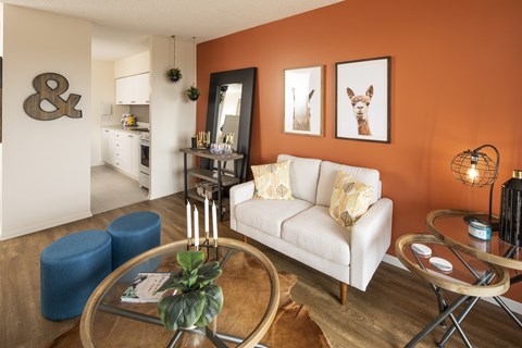 A living room with a white couch and a coffee table.