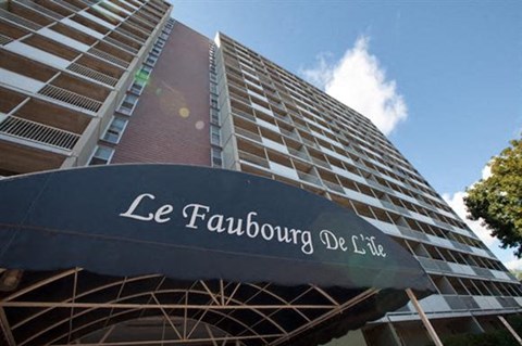 a tall building with a black sign in front of it