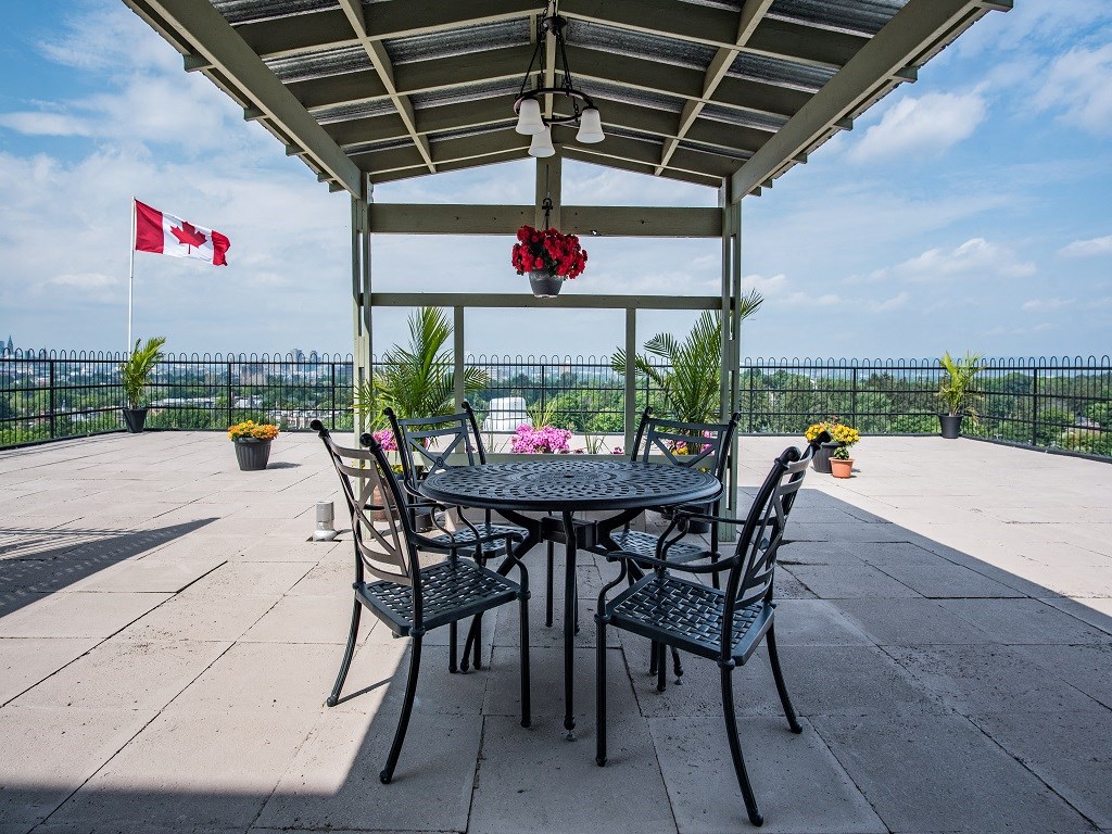 a patio with a table and chairs and a flag