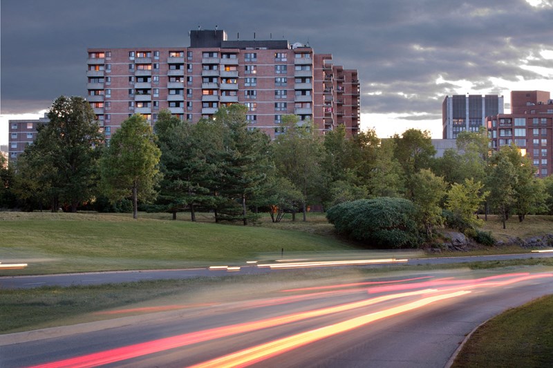 a long exposure photo of a street with a building in the background