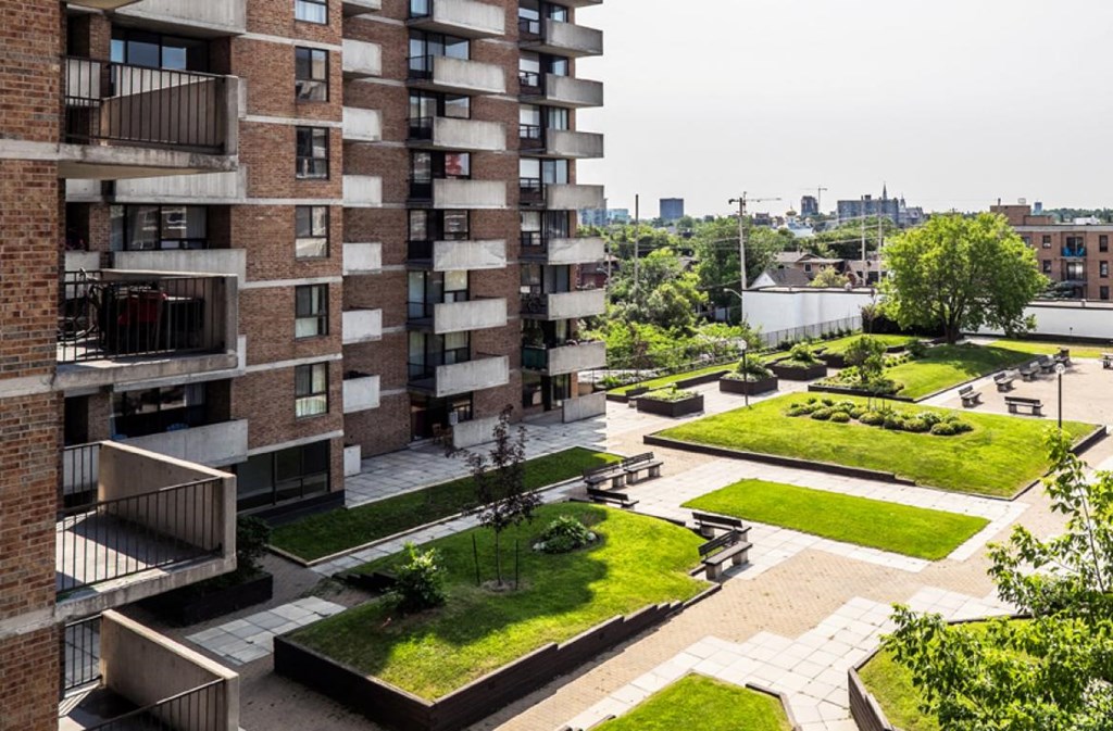 a view of an apartment building with a park in front of it