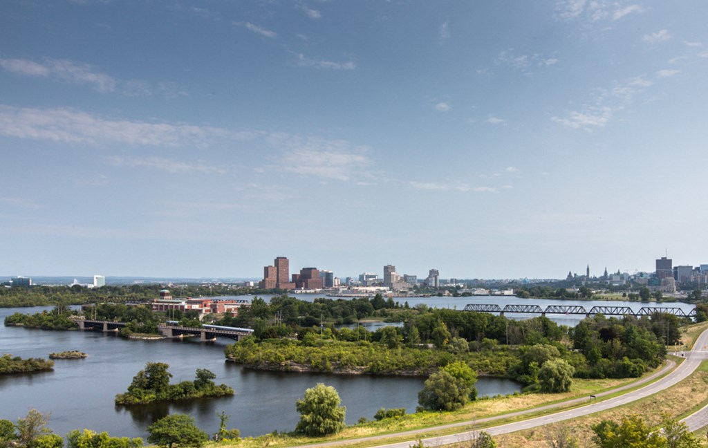 an aerial view of the city with a river and a bridge
