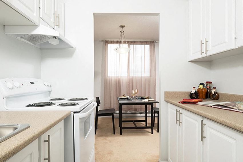 a kitchen with a table and chairs and a stove