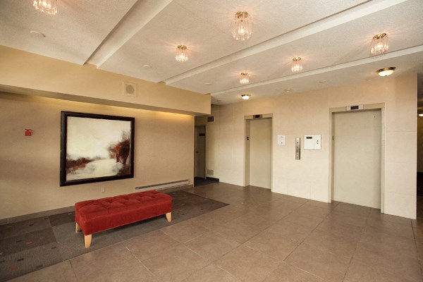 a large room with a red couch and a painting on the wall