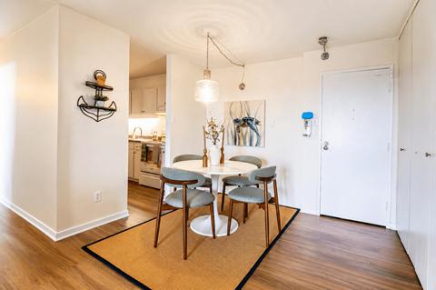 A dining room with a table and chairs.