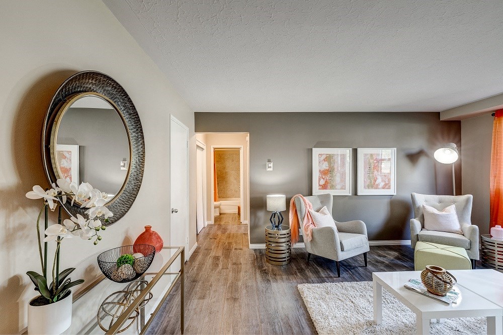 an open living room with furniture and a mirror