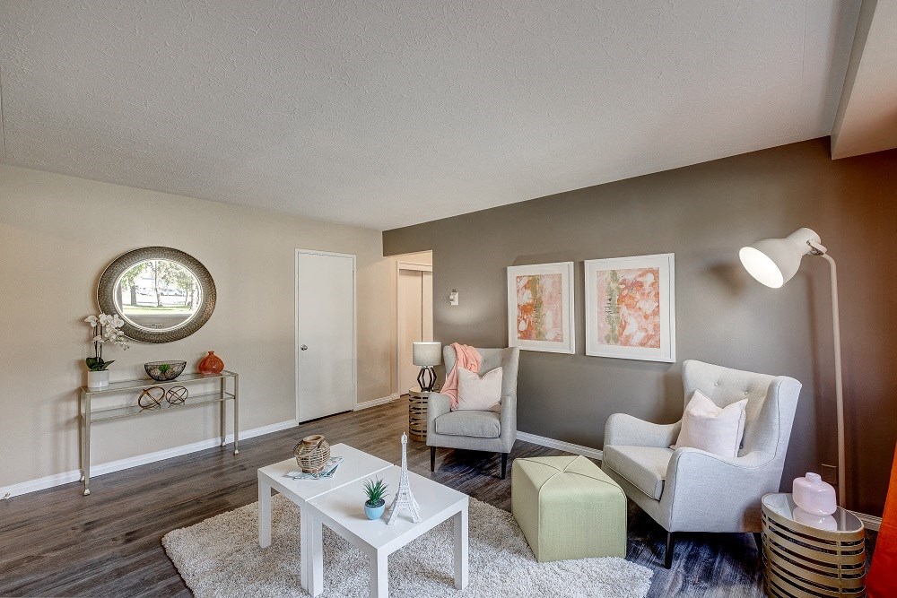 an open living room with furniture and a mirror