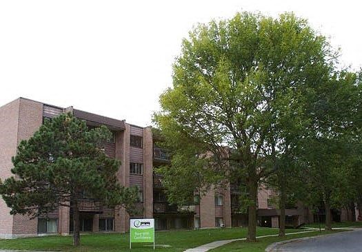 a large brick building with trees in front of it