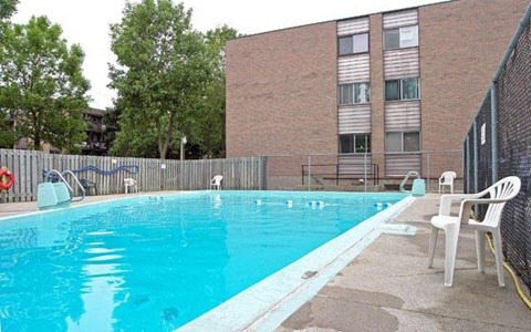 a swimming pool in front of a building