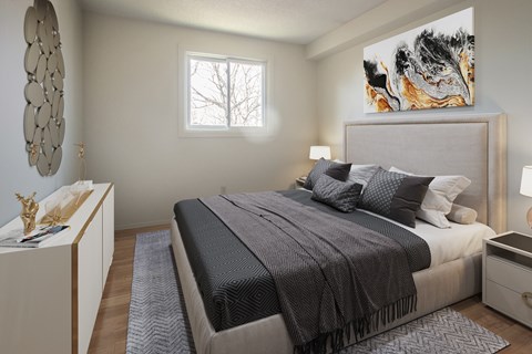 A bedroom with a large bed and a painting on the wall.