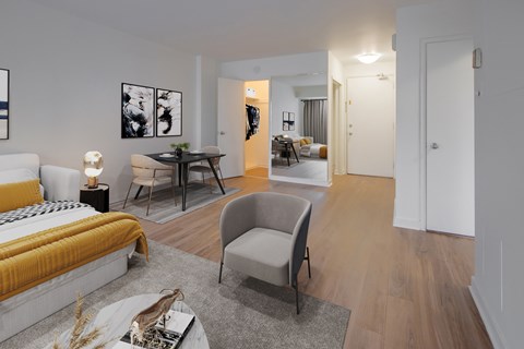 A modern bedroom with a yellow bed and a grey armchair.