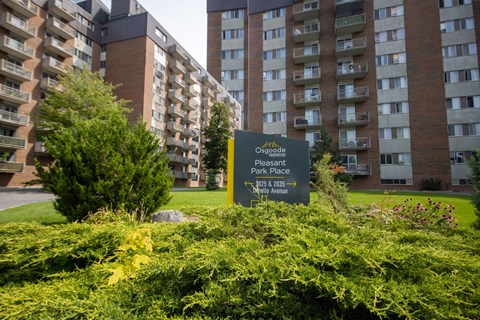 A sign in front of a building that says "Oscogles Pleasant Park Place 2025 2025 2025".
