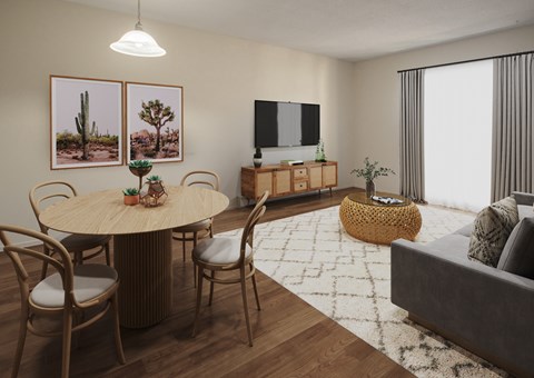 A living room with a round table surrounded by chairs and a flat screen TV mounted on the wall.