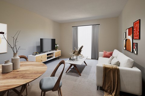A living room with a white couch, a wooden table, and a television.
