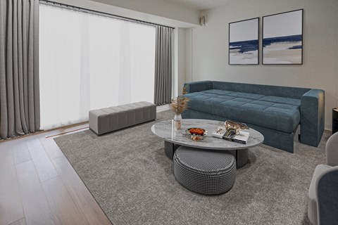 A living room with a grey sofa, a grey coffee table, and a grey ottoman.