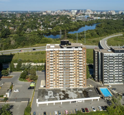 A large building with a pool in front of it.