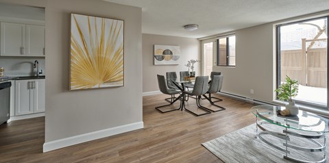 A dining room with a glass table and chairs.