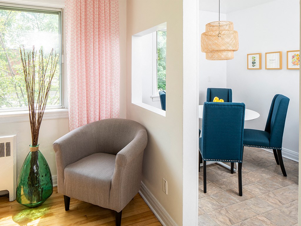 a living room and dining room with a table and chairs