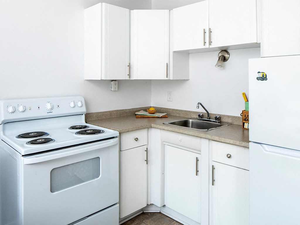 a kitchen with white appliances and white cabinets