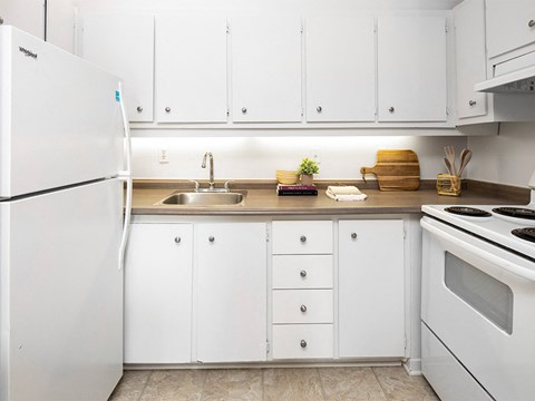 a white kitchen with white appliances and white cabinets