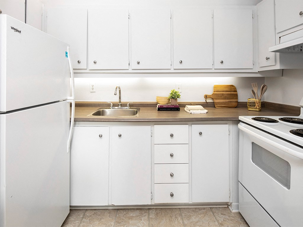a white kitchen with white appliances and white cabinets