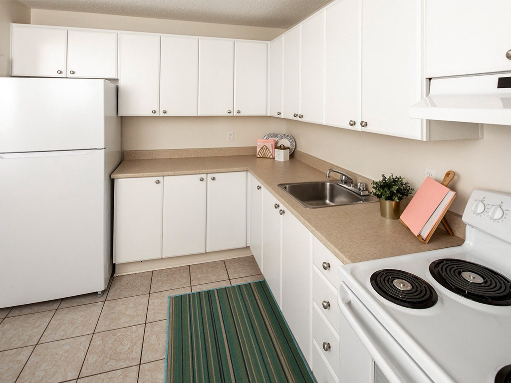 a kitchen with white appliances and white cabinets
