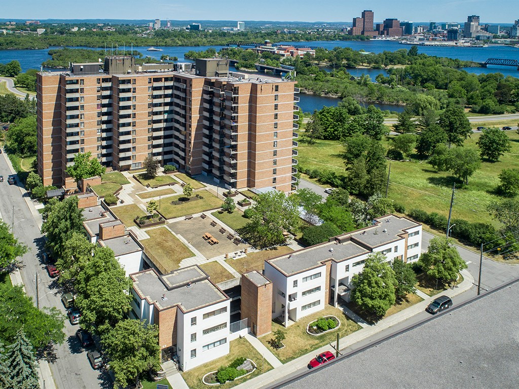 an aerial view of an apartment complex with a river in the background