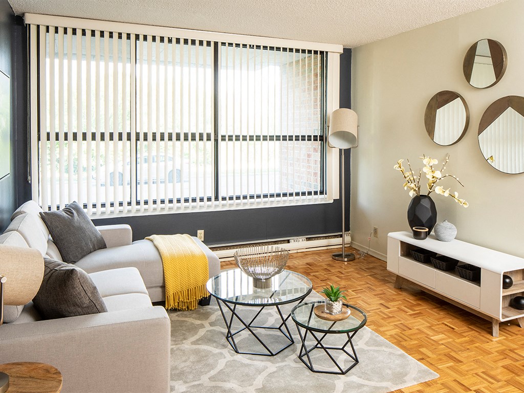 a living room with a large window and a couch and a table