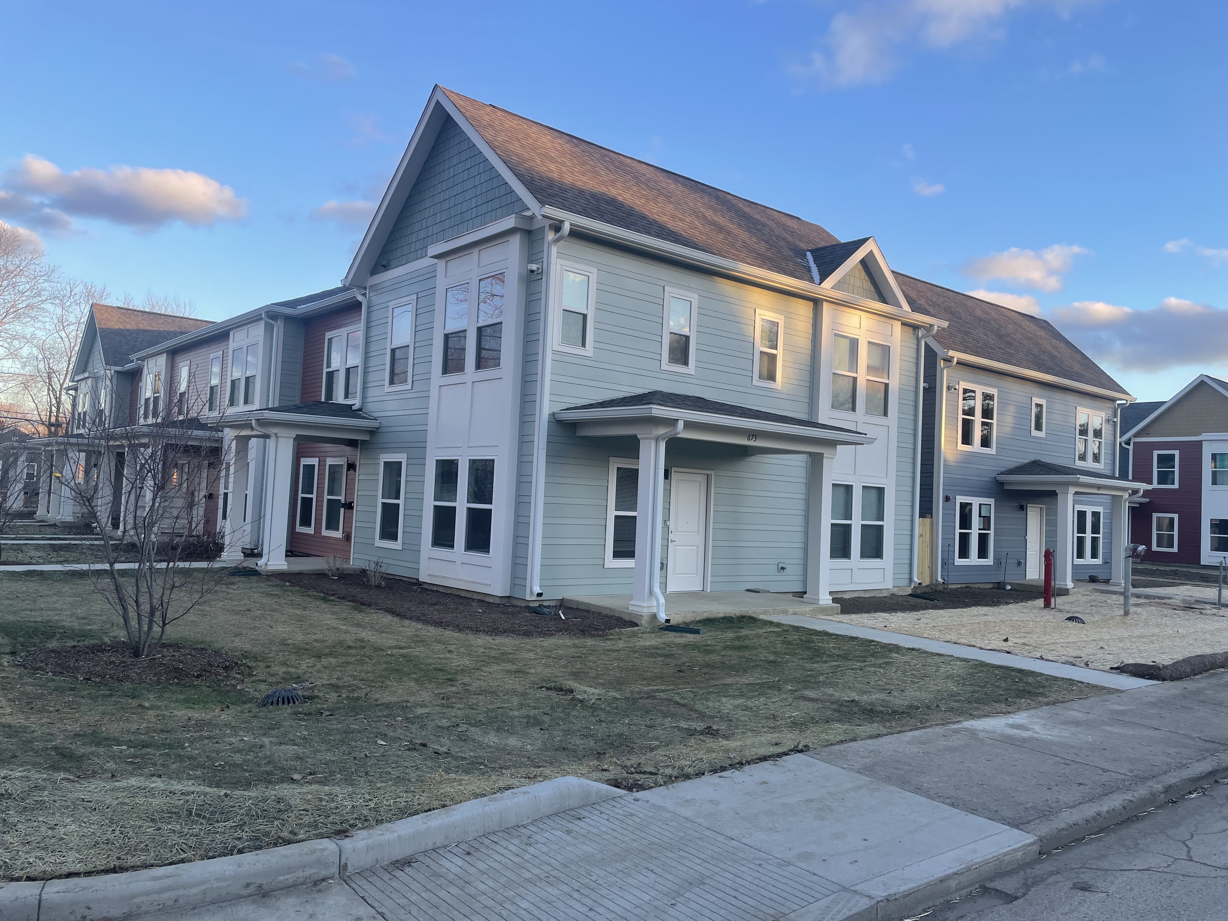 A row of houses with a clear blue sky above them.