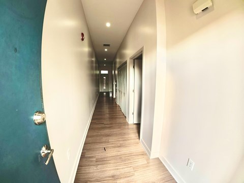A long hallway with doors on both sides.