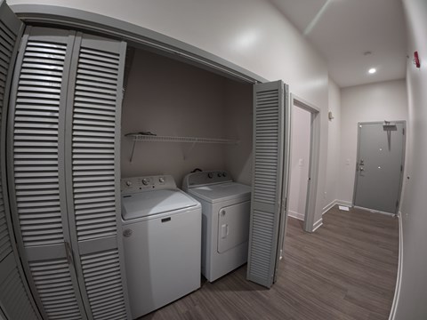 A laundry room with a washer and dryer in it.