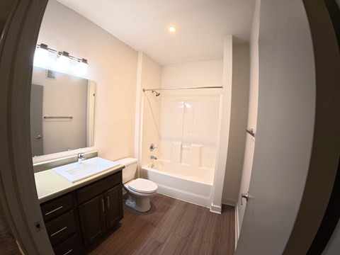 A bathroom with a toilet, sink, and bathtub.