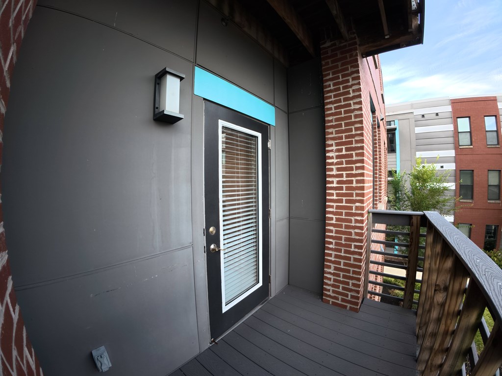A balcony with a door and a window.