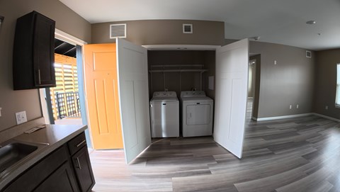 A kitchen with a sink, a refrigerator, and a microwave.